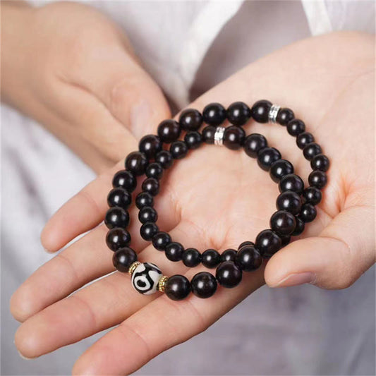 Pulsera Tibetana de Madera Ébano con Cuenta Dzi – Doble Vuelta
